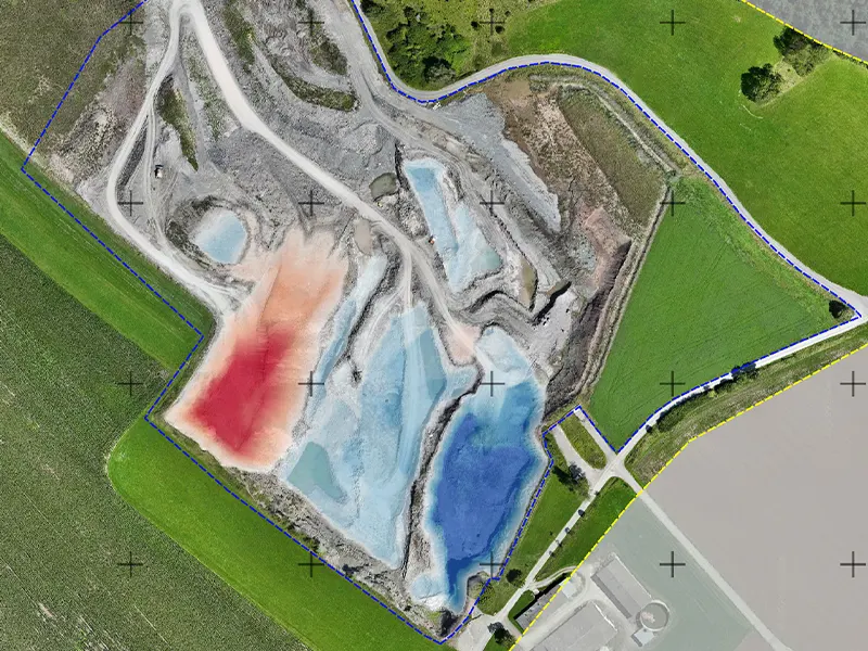 Cut/fill change map comparing two 3D survey dates, with color-coded areas showing terrain height differences for volume and mass determination.